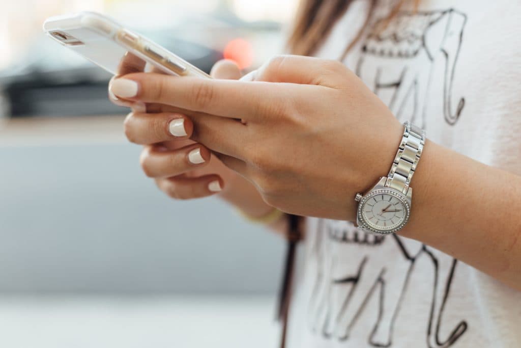 Close up of hands holding a phone