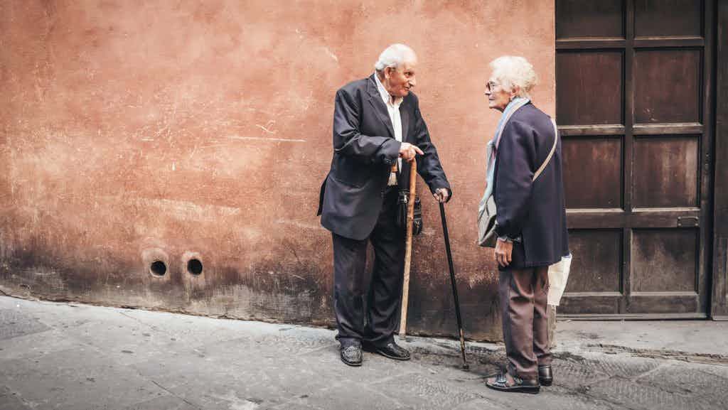 Elderly Gentlemen talking in front of a door