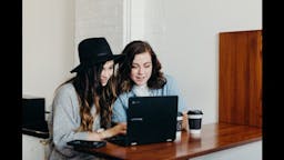 Two girls looking at computer