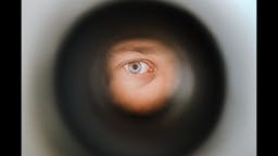 person looking through peephole